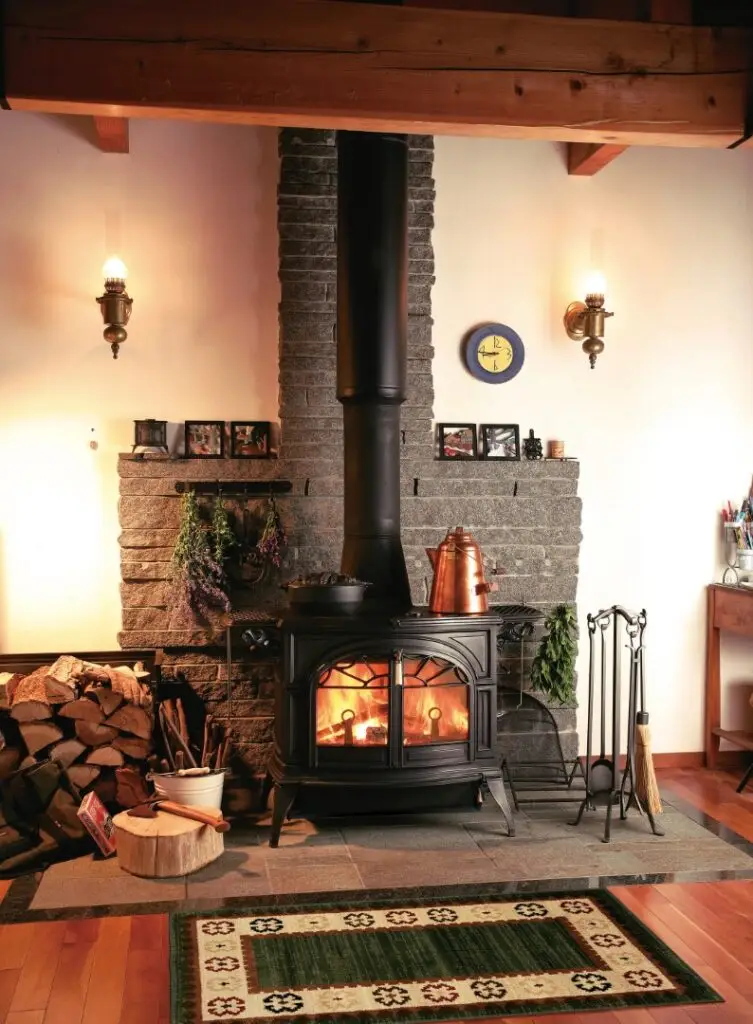 Vermont Castings Defiant Classic Black Wood Stove with a warm wood fire burning
