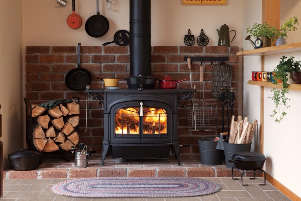 Vermont Castings Encore Classic Black Wood Stove with a cozy wood fire burning.