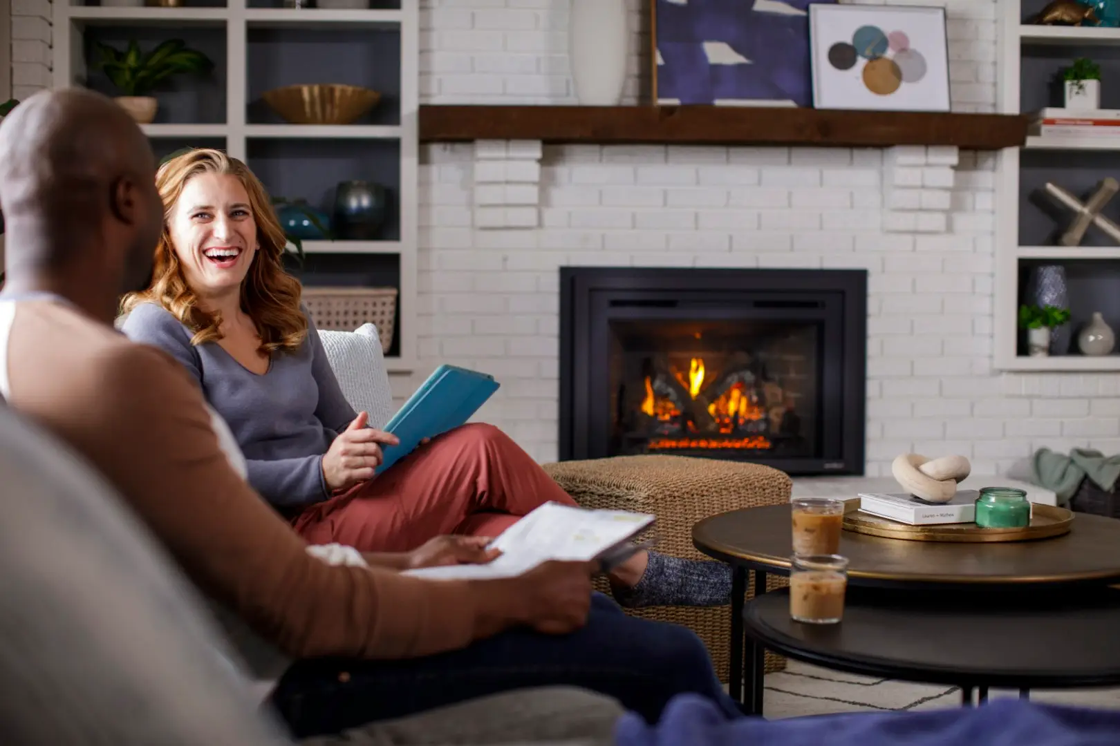 Couple relaxing in front of their Escape gas fireplace insert