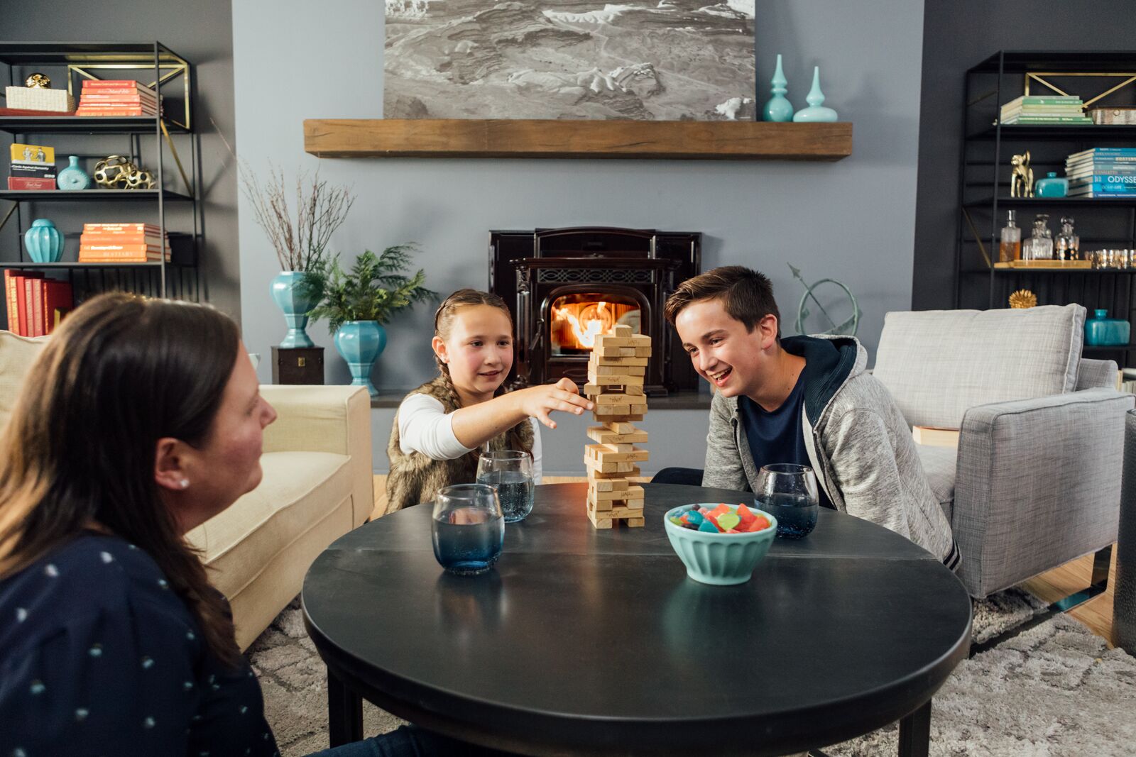 Family playing games next to pellet fireplace insert