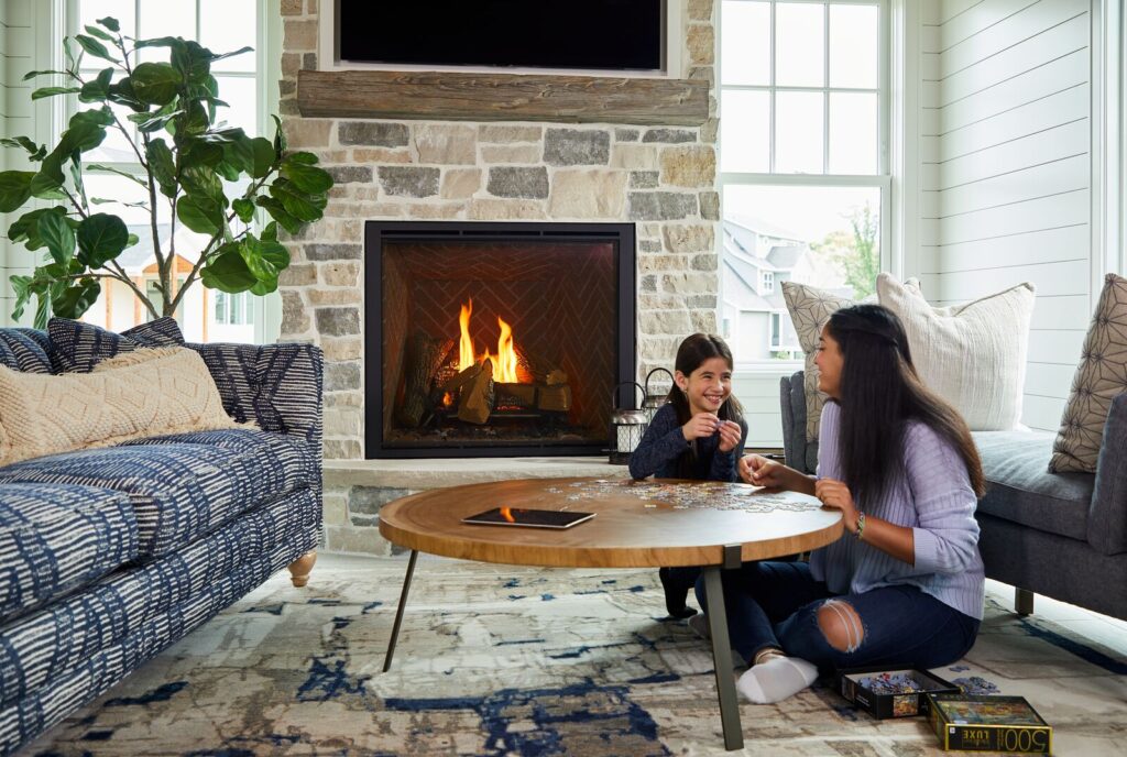 Mom and daughter enjoying a gas fireplace