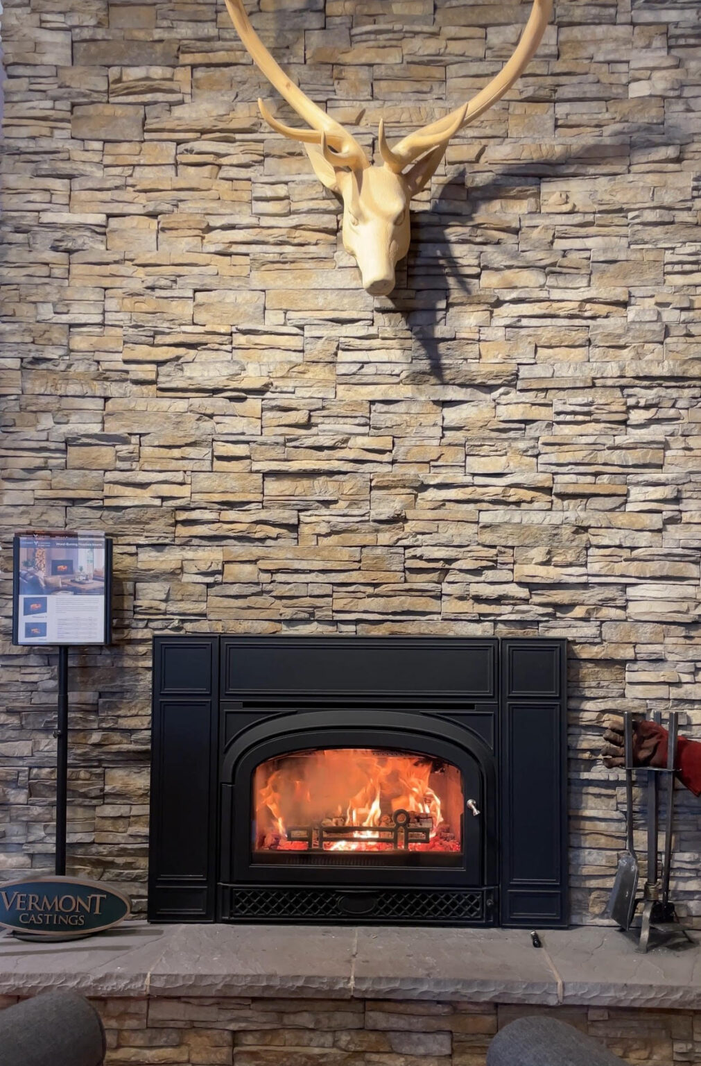 wood fireplace insert burning in the stove shop fireplace experts phoenixville, pa montpellier from vemont castings in black with stone backing and wood deer with large set of antlers