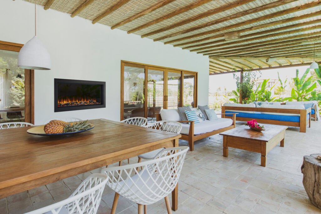 outdoor electric fireplace white modern home overhang beautiful day wood table and white floors