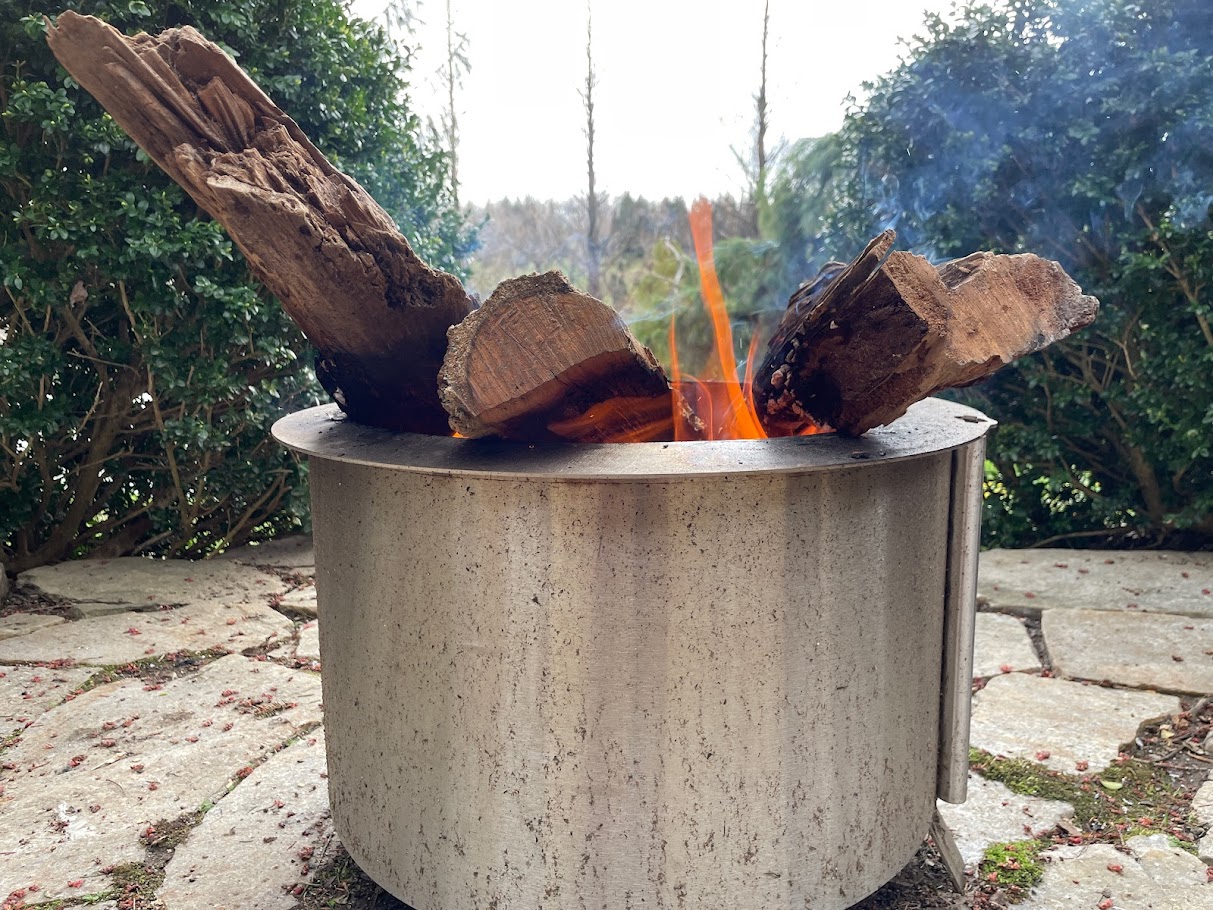 firepit closeup with flames and wood sticking out